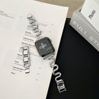 Apple Watch bracelet with wavy metal links, modern S-shaped design, adjustable push-button clasp, Sydia model